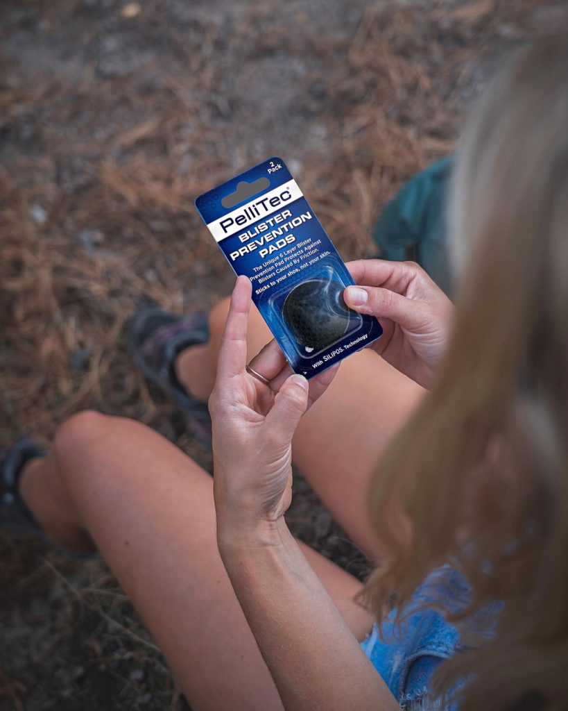 Hiker holding a pack of PelliTec blister prevention pads
